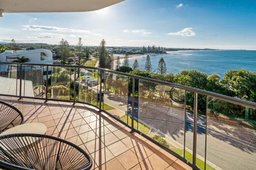 a balcony with chairs and a view of the ocean at Ocean Front Views with Rooftop Terrace in Caloundra