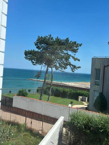 a view of the beach from the balcony of a house at MAV Beach Villa in Eforie Nord
