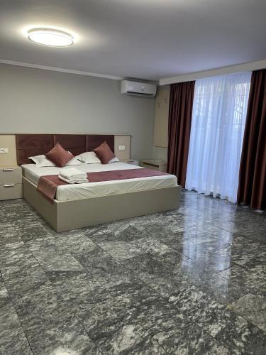 a bedroom with a large bed in a room at MAV Beach Villa in Eforie Nord