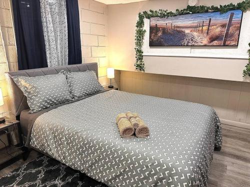 a bedroom with a bed with shoes on it at Serene Cityscape Sanctuary Close to Downtown Indianapolis - Unit #5 in Indianapolis