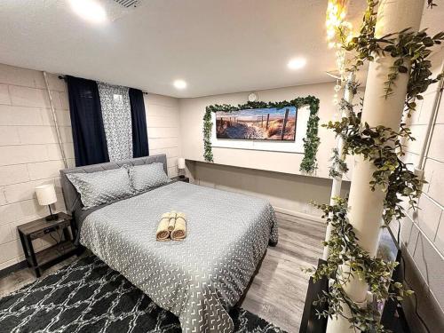 a bedroom with a bed with a pair of shoes on it at Serene Cityscape Sanctuary Close to Downtown Indianapolis - Unit #5 in Indianapolis