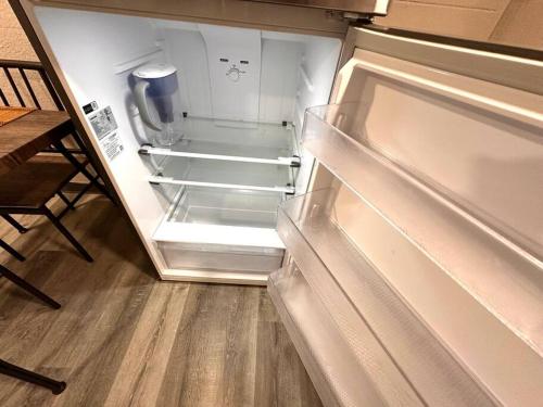 an empty refrigerator with its door open in a kitchen at Serene Cityscape Sanctuary Close to Downtown Indianapolis - Unit #5 in Indianapolis
