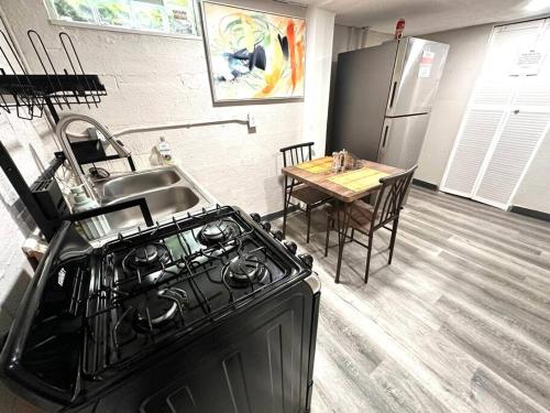 a kitchen with a black stove and a table at Serene Cityscape Sanctuary Close to Downtown Indianapolis - Unit #5 in Indianapolis