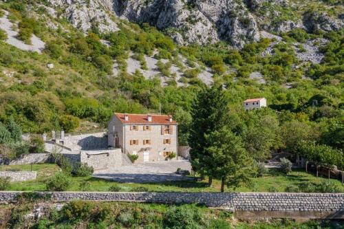 an aerial view of a house on a mountain at Villa Sveti Stefan in Budva