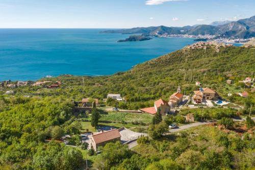 an aerial view of a house on a hill next to the ocean at Villa Sveti Stefan in Budva