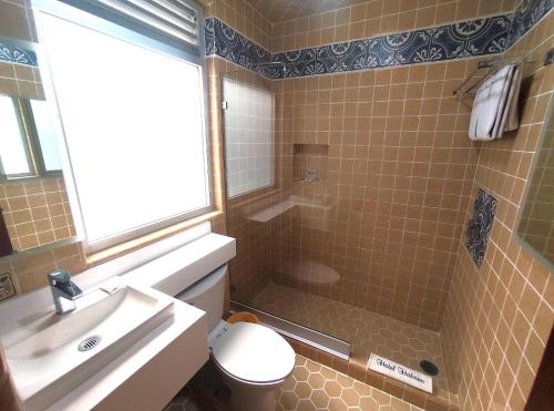 a bathroom with a shower and a toilet and a sink at Hotel Habana in Mexico City