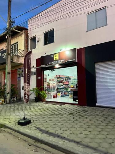a store with a sign in front of a building at Temporada BHS Quarto 2 in Barreirinhas