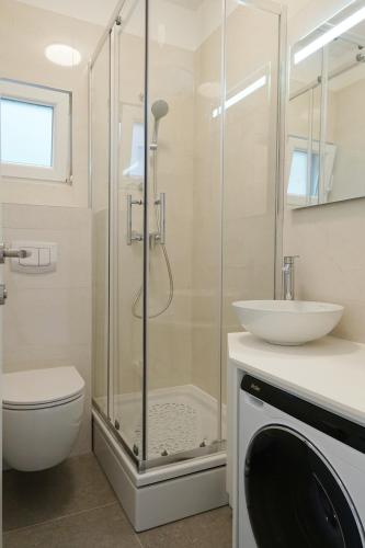 a bathroom with a shower and a toilet and a sink at Apartments with parking space Marusici, Omis - 657 in Mimice