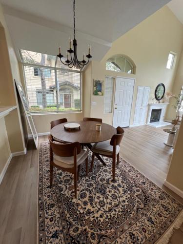 a dining room with a table and chairs on a rug at Luxury Private Master Suite With Mountain View in Rancho Santa Margarita