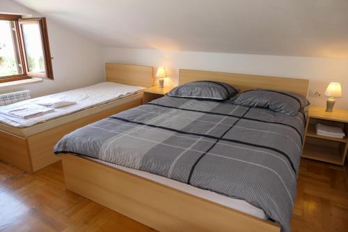 a bedroom with two beds and two lamps at Apartments with parking space Senj - 15376 in Senj