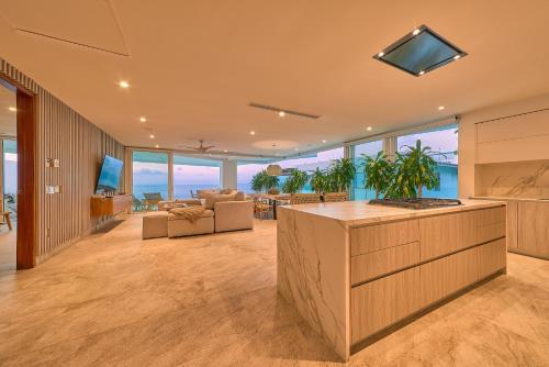 an open kitchen and living room with a view of the ocean at Maxwell Residences at Indah in Puerto Vallarta