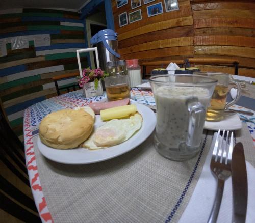 a table with a plate of food on a table at Hostel 53 Sur in Puerto Natales