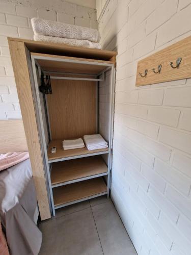 a small closet in a room with white walls at CalaRosa Condomínio in Praia do Rosa