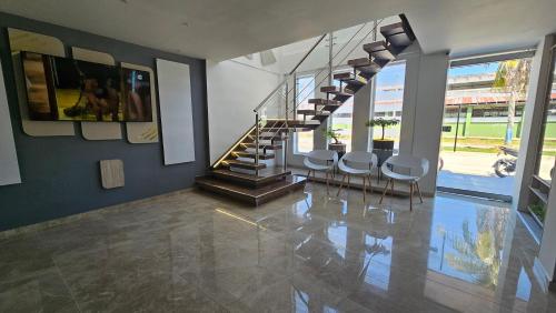 a room with a staircase with chairs and a stair case at Waldor's Hotel Boutique in Leticia