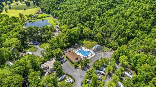 an aerial view of a park with a house and a lake at Creekside Glamping Resort- Fishing Pond, Mini Golf, Game Room, Pet Friendly in Gatlinburg