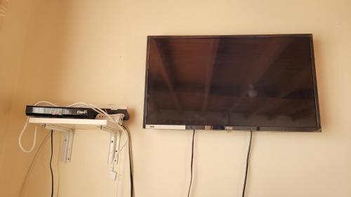 a flat screen tv hanging on a wall at Puesta del Sol in Pelluhue