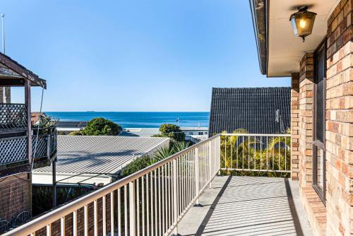 a balcony with a view of the beach at Spacious Ocean View Home in Noraville in Norah Head