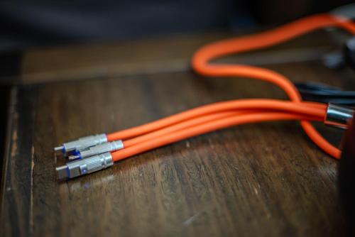 an orange cable with a screwdriver on a wooden table at Spacious Ocean View Home in Noraville in Norah Head
