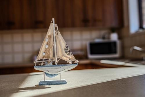 a miniature sail boat on a counter in a kitchen at Spacious Ocean View Home in Noraville in Norah Head