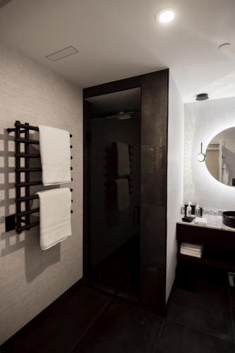 a bathroom with a sink and a mirror and towels at the reid hotel in Vanderhoof