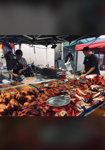 a table with many different types of food on it at City hotel in Sibu