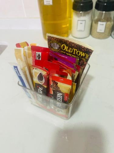 a plastic container filled with candy on a counter at HARRAZ SUITE PUTRAJAYA just minutes away from PICC and KPT perfect for both business and leisure stays in Putrajaya