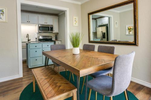 a dining room with a wooden table and a mirror at The Casino Cottage in Durant
