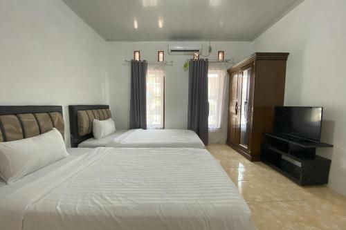 Ένα ή περισσότερα κρεβάτια σε δωμάτιο στο Guesthouse Pondok Amak