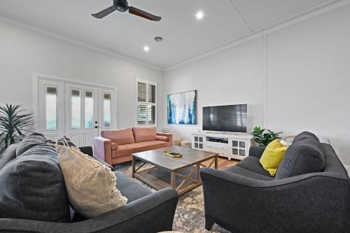 a living room with two couches and a tv at Dunkley House - Large CBD Heritage Home, Sleeps 10 in Bathurst