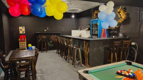 a bar with a pool table and balloons at Casa Samor La Candelaria in Bogotá