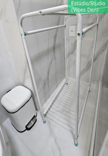 a white toilet in a bathroom with a white wall at Copacabana Vibes Studios in Rio de Janeiro