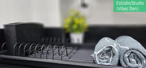 a dish drying rack with towels on a counter at Copacabana Vibes Studios in Rio de Janeiro