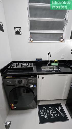 a small kitchen with a stove and a sink at Copacabana Vibes Studios in Rio de Janeiro
