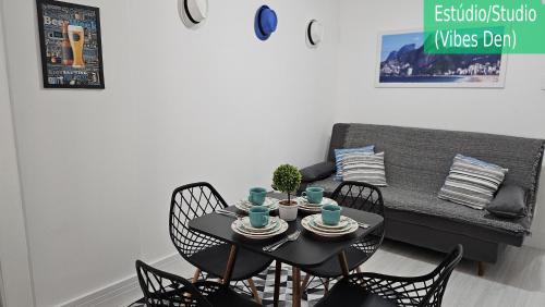 a table and chairs in a living room with a couch at Copacabana Vibes Studios in Rio de Janeiro