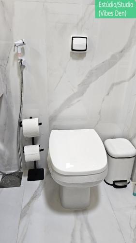a white bathroom with a toilet and a shower at Copacabana Vibes Studios in Rio de Janeiro