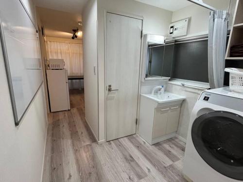 a bathroom with a sink and a washing machine at Cozy inn 西品川101 in Tokyo