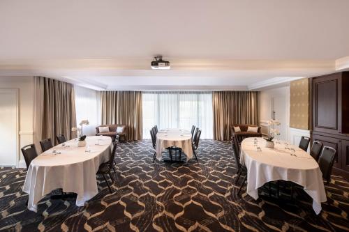 a meeting room with tables and chairs in a hotel at Peppers The Hills Lodge in Castle Hill