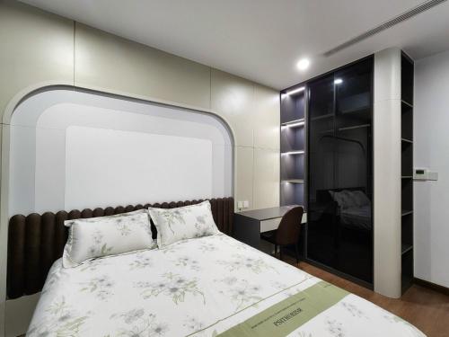 a bedroom with a large bed and a desk at The Matrix One Căn Hộ 3 Phòng Ngủ Tiện Nghi. in Hanoi