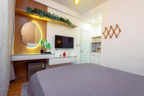 a bedroom with a large bed and a mirror at Hoa Hong Hotel - Xa Dan in Hanoi