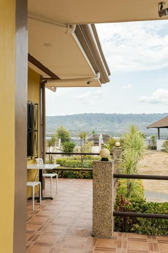 a patio with a view of the ocean from a house at Turtle Bay Dive Resort in Moalboal