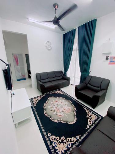 a living room with a couch and a table at HELLOKITTY HOUSE - Unit 3 in Kuala Terengganu