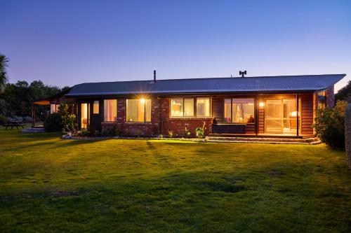 a house with a lawn in front of it at Surfwatch House in Kaikoura