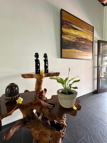 a living room with a table with a plant on it at Bale Solah Lombok Holiday Resort in Senggigi 