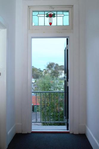 an open door to a balcony with a window at The Caledonian Hotel Wonthaggi in Wonthaggi