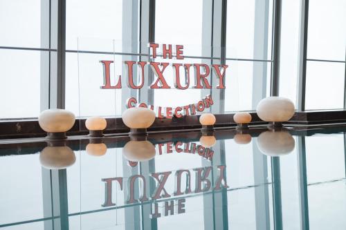a sign for the lobby of a building with glass windows at Na Lotus Hotel, a Luxury Collection Hotel, Nanning in Nanning