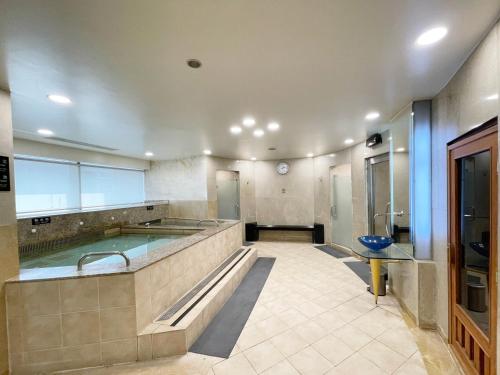 a large bathroom with a swimming pool in it at Hotel Metropolitan Premier Taipei in Taipei