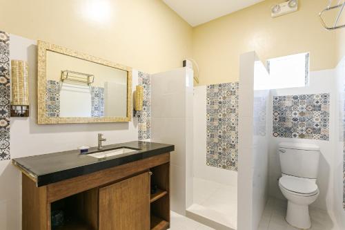 a bathroom with a sink and a toilet at Turtle Bay Dive Resort in Moalboal