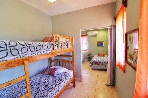 a room with two bunk beds and a bedroom at Casa Brisa, Gran Pacifica in Managua