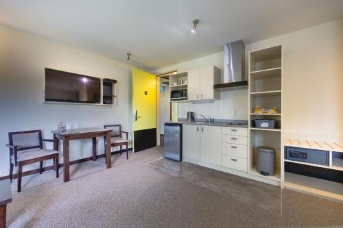 a kitchen with a table and a dining room at Ava Lodge in Lower Hutt