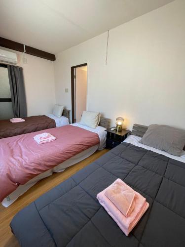 Postel nebo postele na pokoji v ubytování Sea View Court Kobe